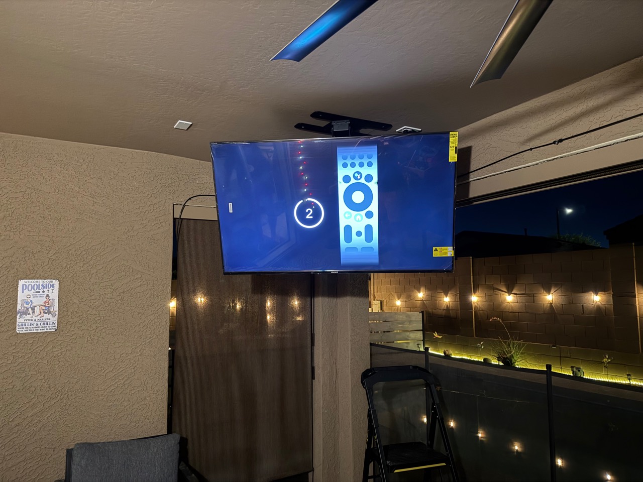 Real VistaMount outdoor ceiling-mounted TV detail on a Phoenix stucco patio